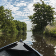 The bow of a canoe on a calm lake.